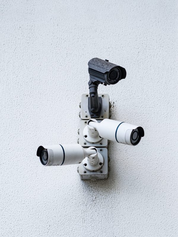 Security cameras on white modern building, technology concept